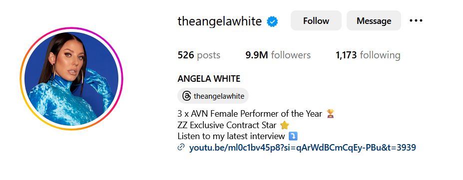 profile picture from the Instagram of Angela White in a shiny blue outfit