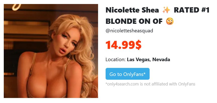 wearing a low-cut outfit indoors, Nicolette Shea poses under warm lighting