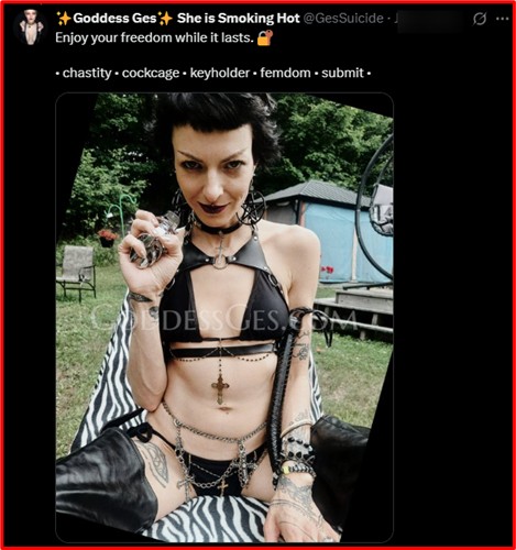 person in black leather outfit holding chastity keys, sitting outdoors in dominant pose