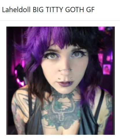 purple and black hair, nose piercings, and chest tattoos, Lahel Doll