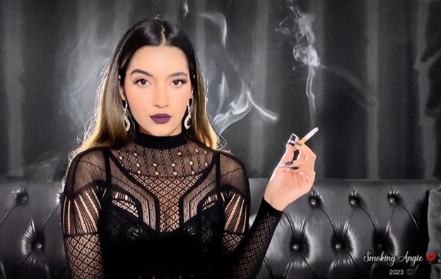 woman in black mesh outfit holding cigarette with smoke swirling in background